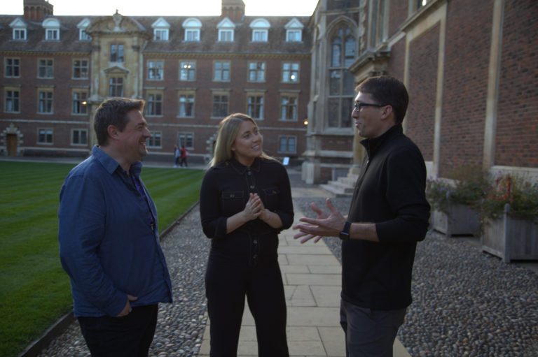 three venture builder founders stand discussing their climate tech ideas in st Catharine's college, Cambridge