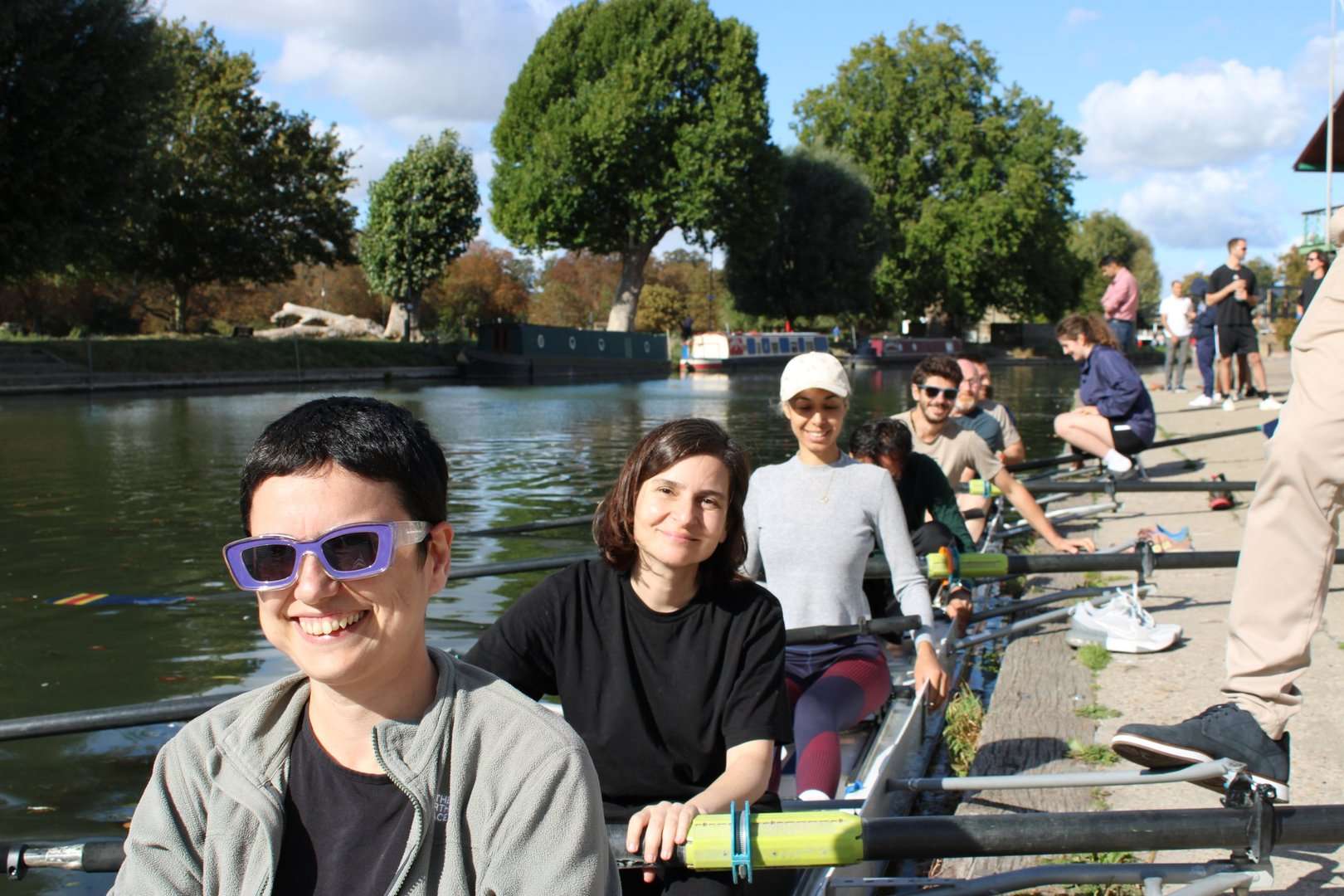Cohort 11 founders seated in a rowing boat at the boathouse on the River Cam